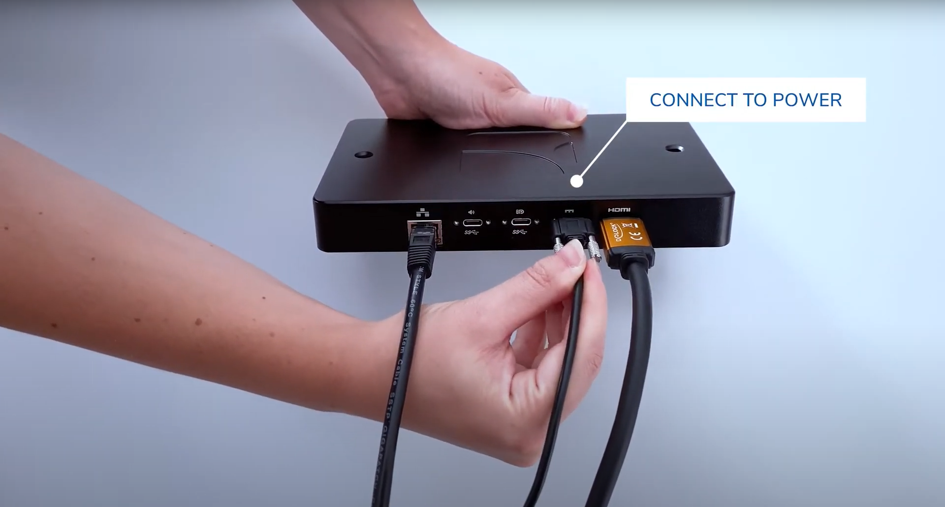 power cable being connected to a SpinetiX HMP digital signage player